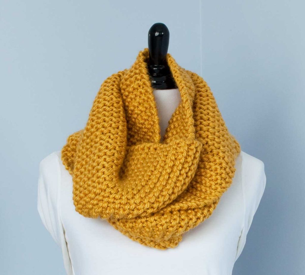 Mustard Yellow Scarf draped around the neck of a dressmakers dummy