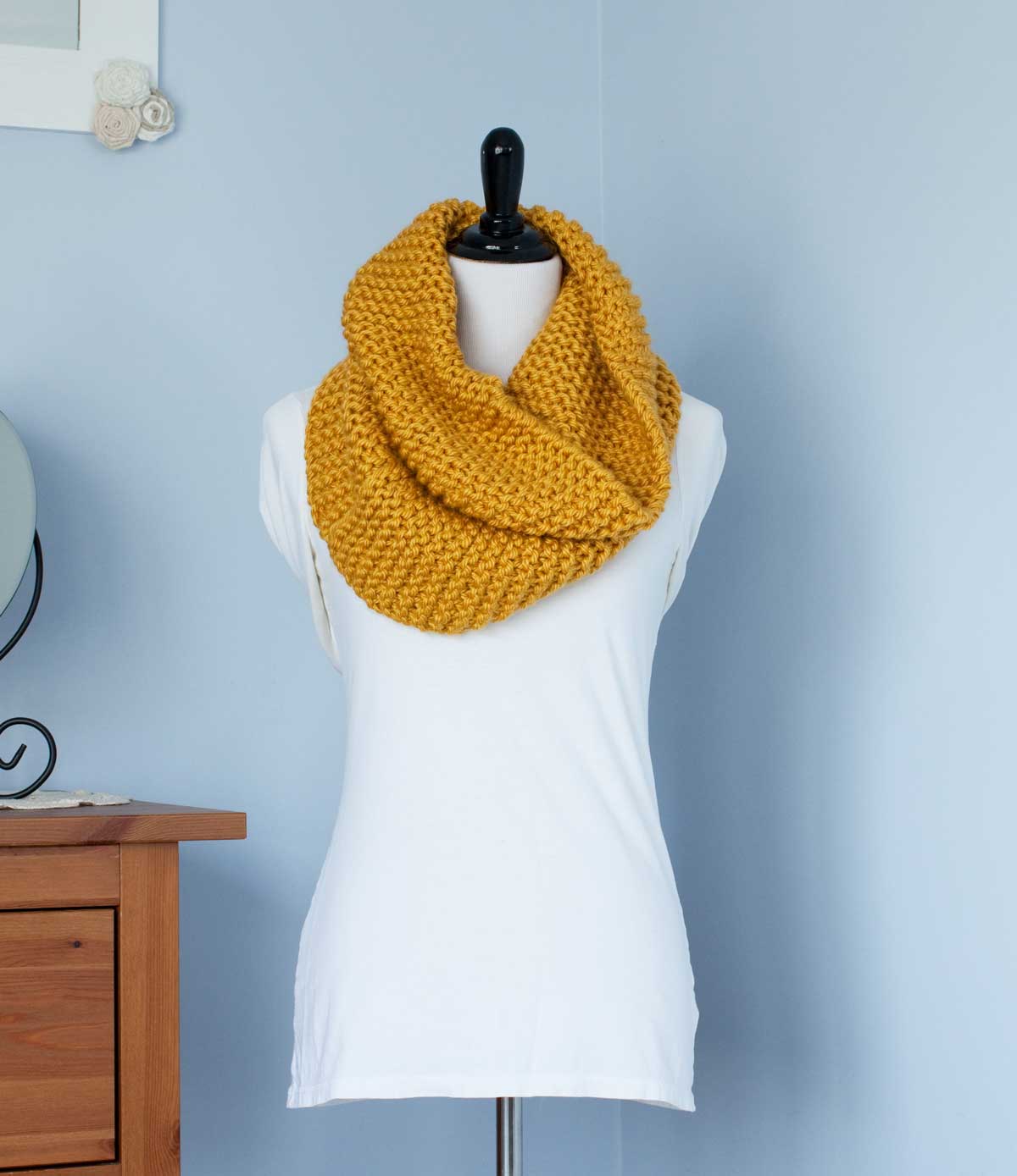 Mustard yellow scarf wrapped around a a dress-makers dummy.
