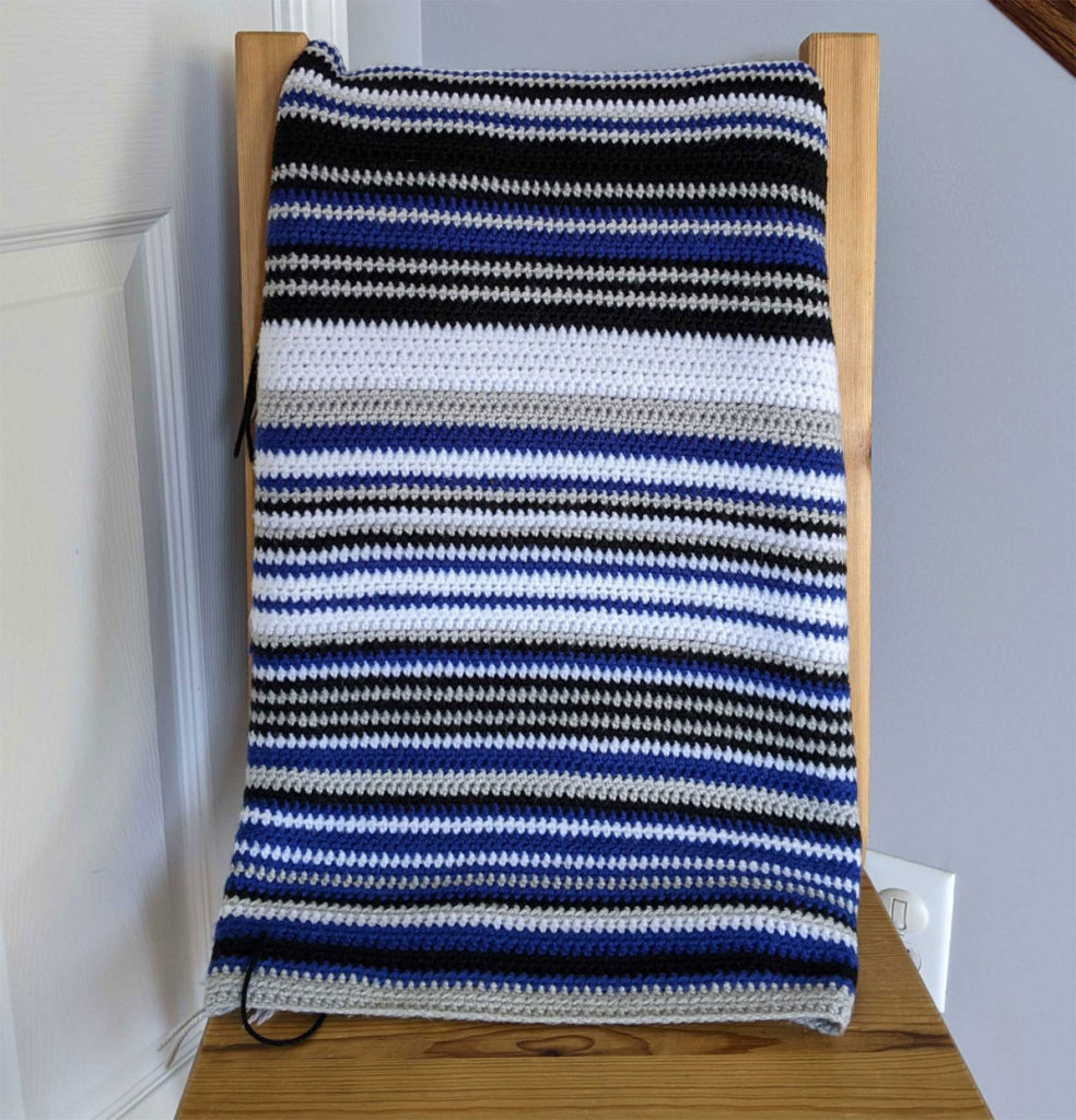 Striped blanket folded over chair